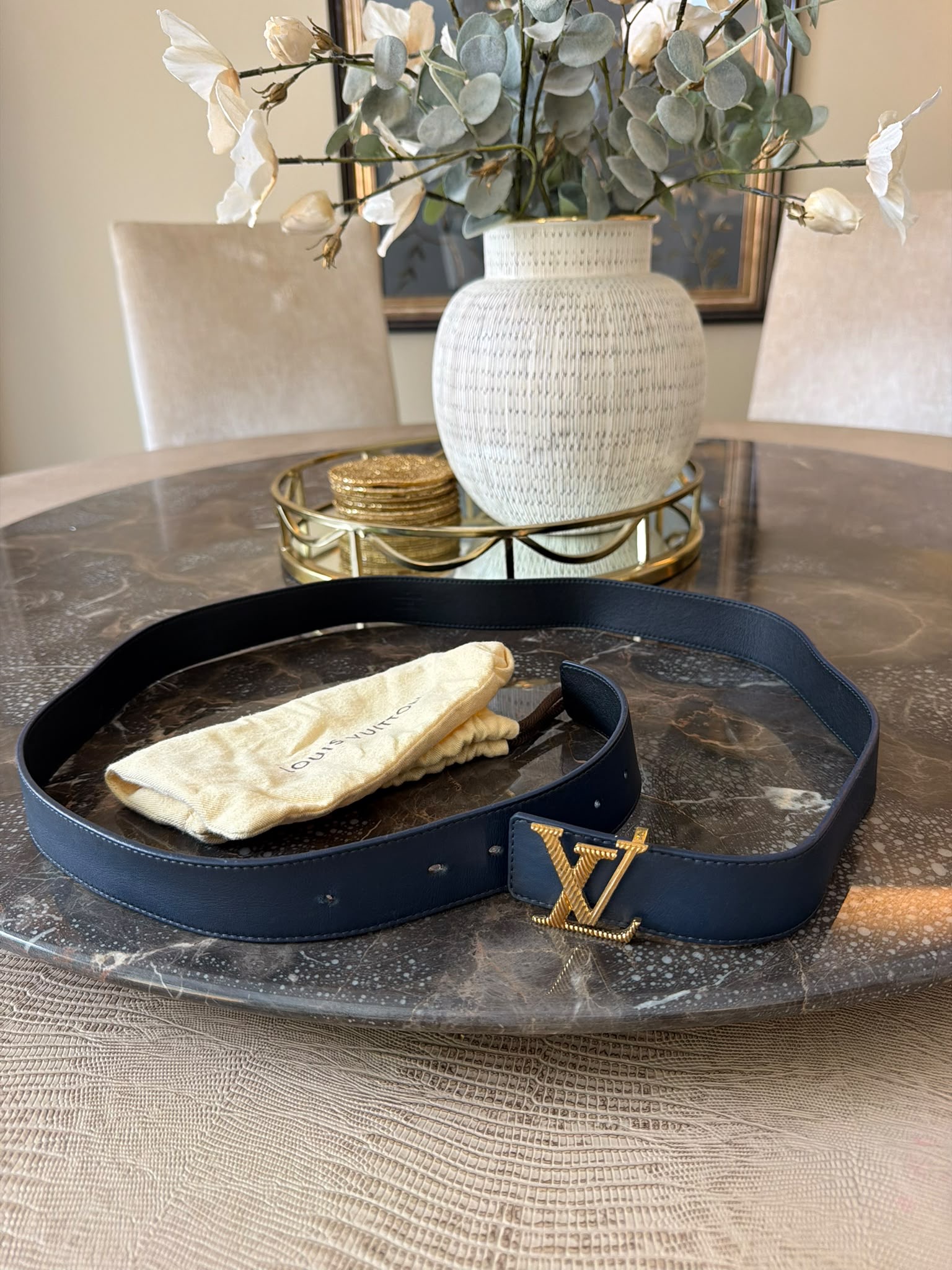 Louis Vuitton M0209 belt rolled on Louis Vuitton dust bag