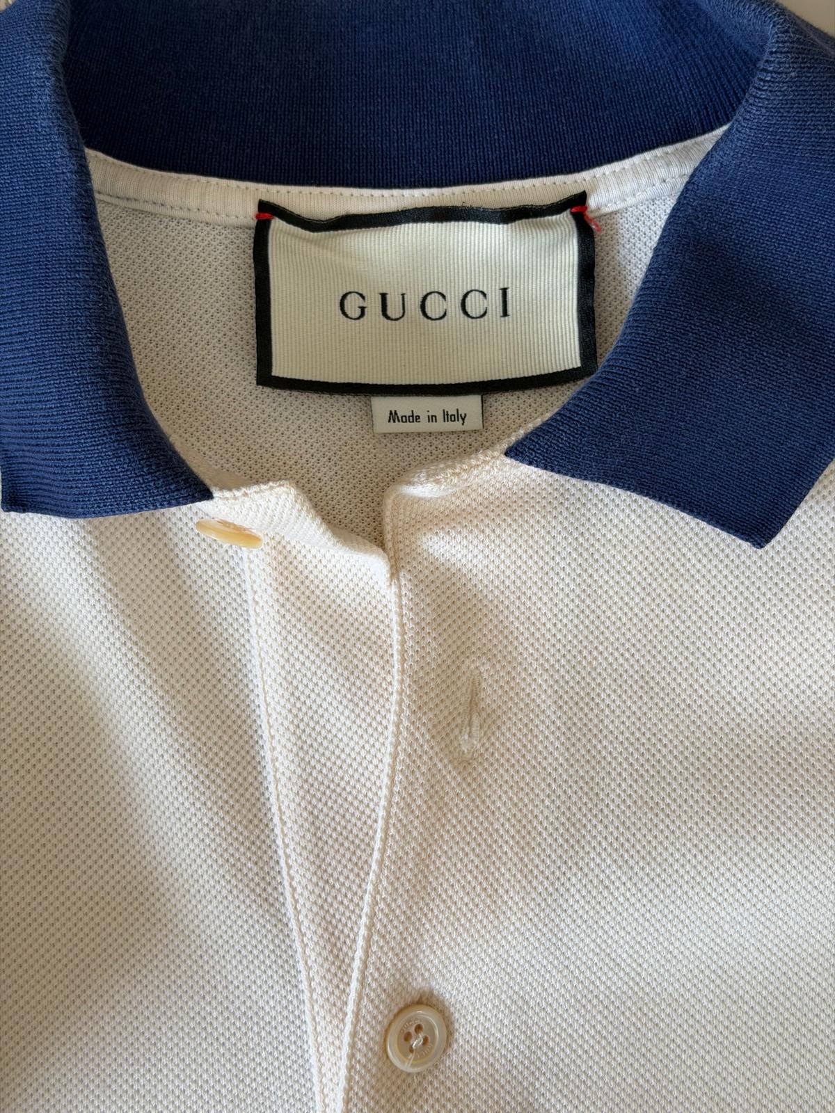 Gucci size L care label on off white polo