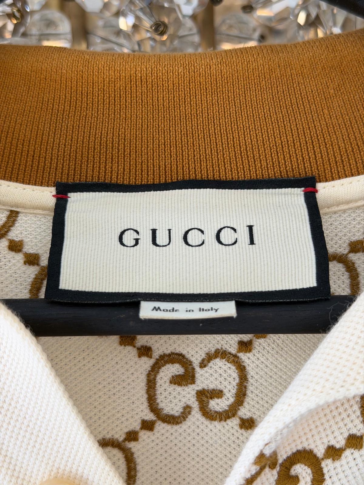 Close-up of Gucci ivory polo with camel GG embroidery