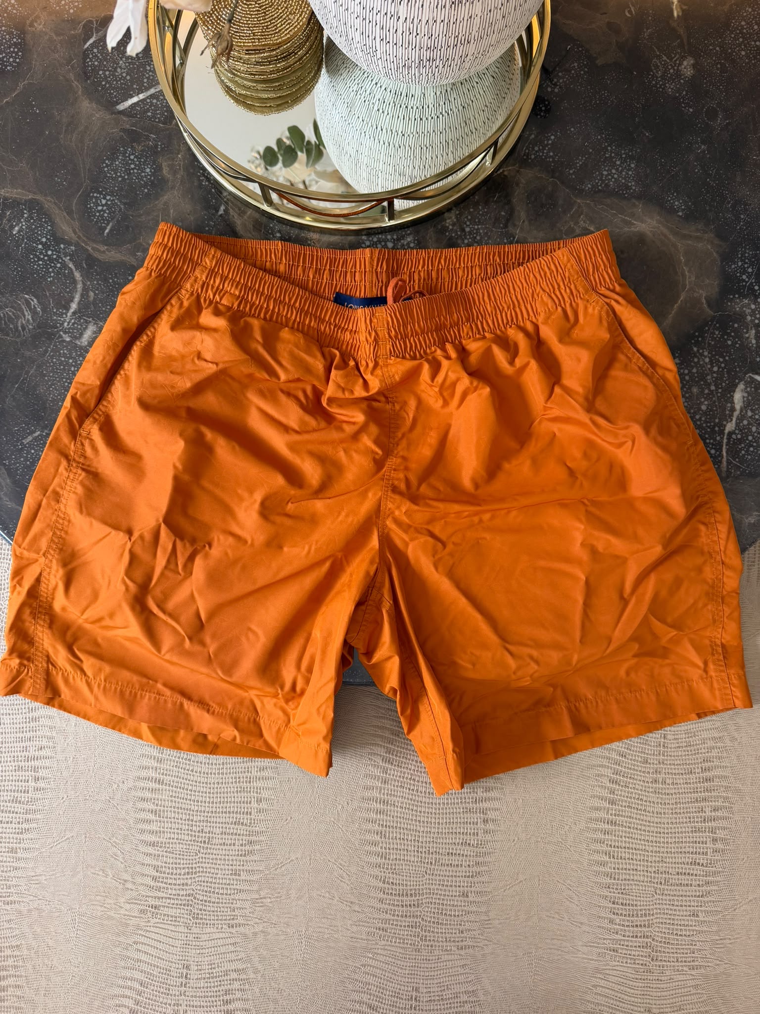 Louis Vuitton orange swim shorts with tonal LV Monogram pattern