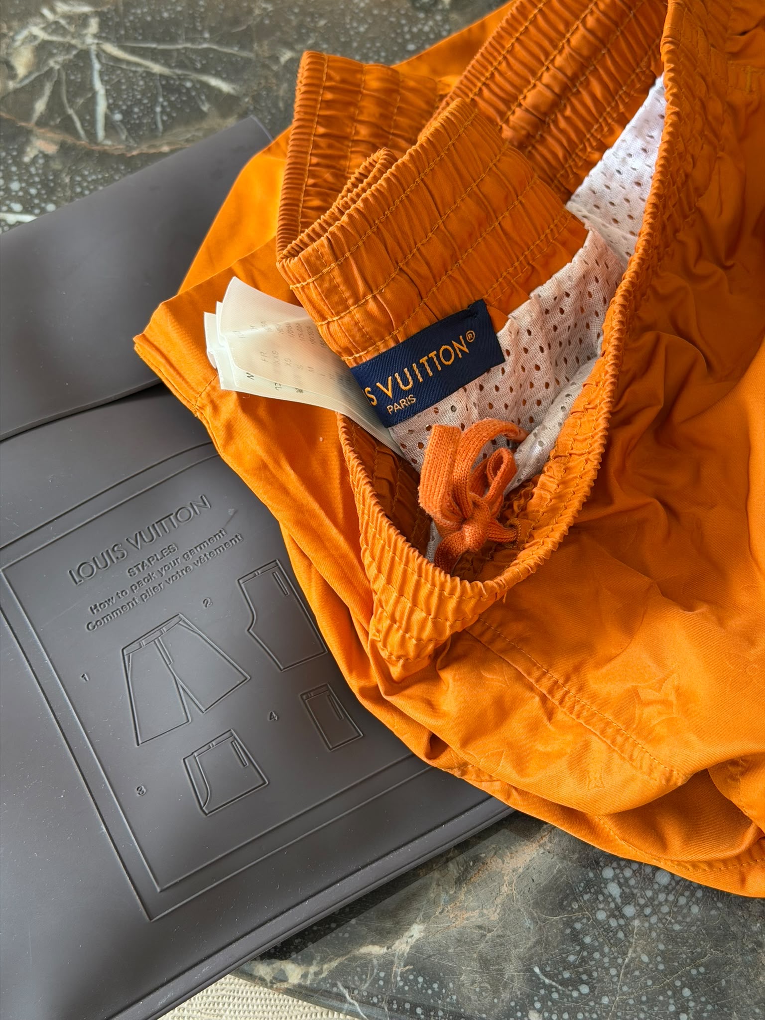 Rear view of Louis Vuitton orange Monogram swim shorts