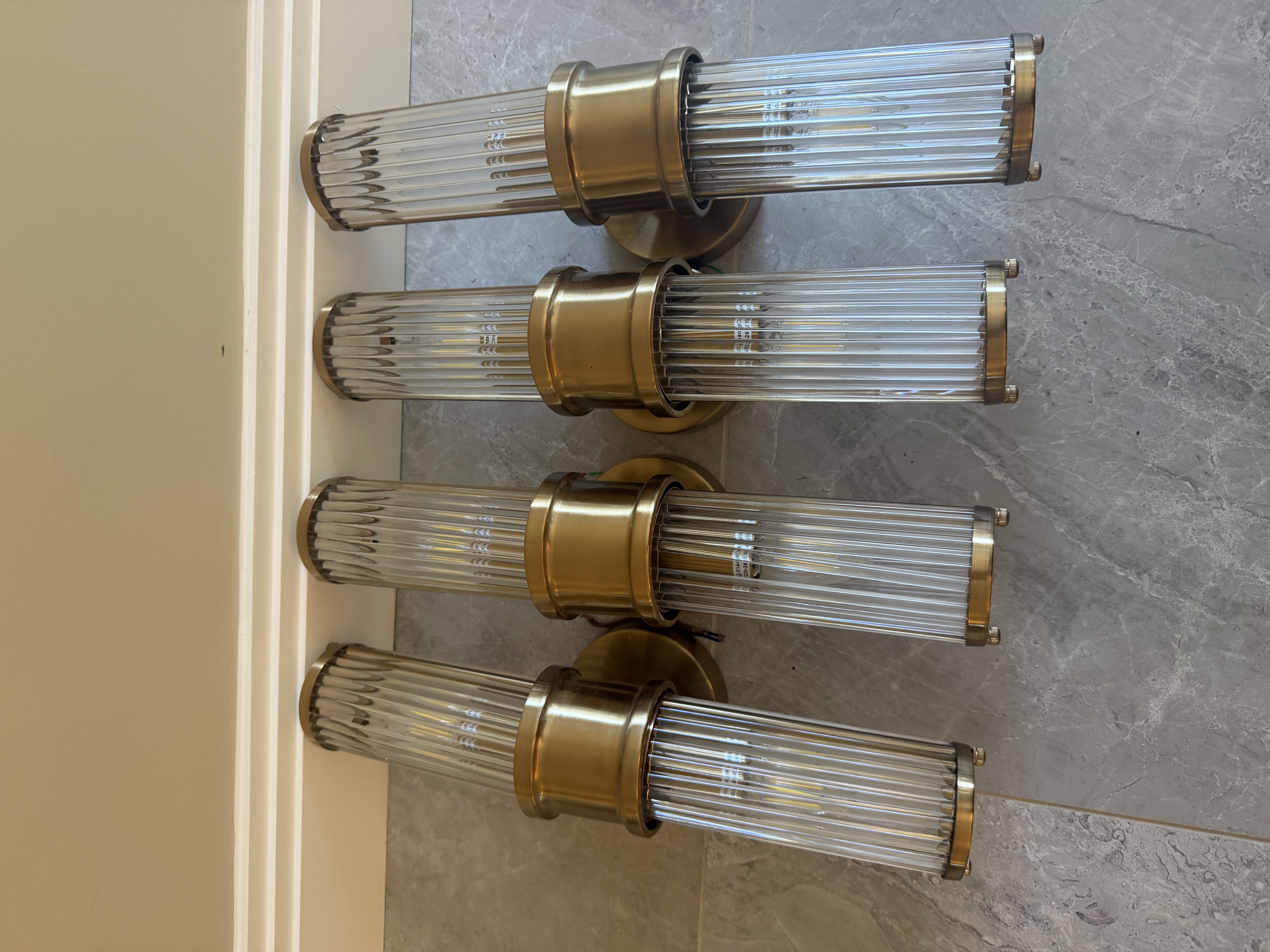 Set of four Eichholtz Glorious XL matte brass and clear glass wall lamps
